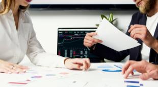 Deals being made at a desk with a man and woman