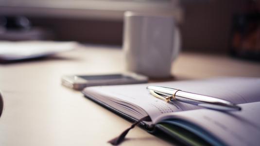 desk with pen and cup