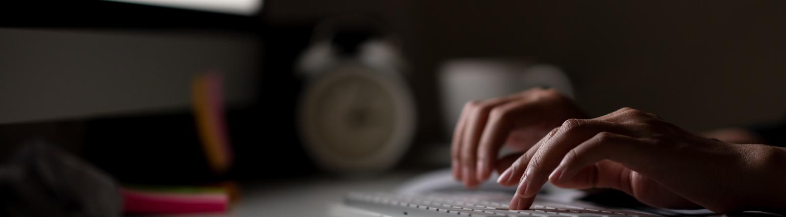 computer with typing hands