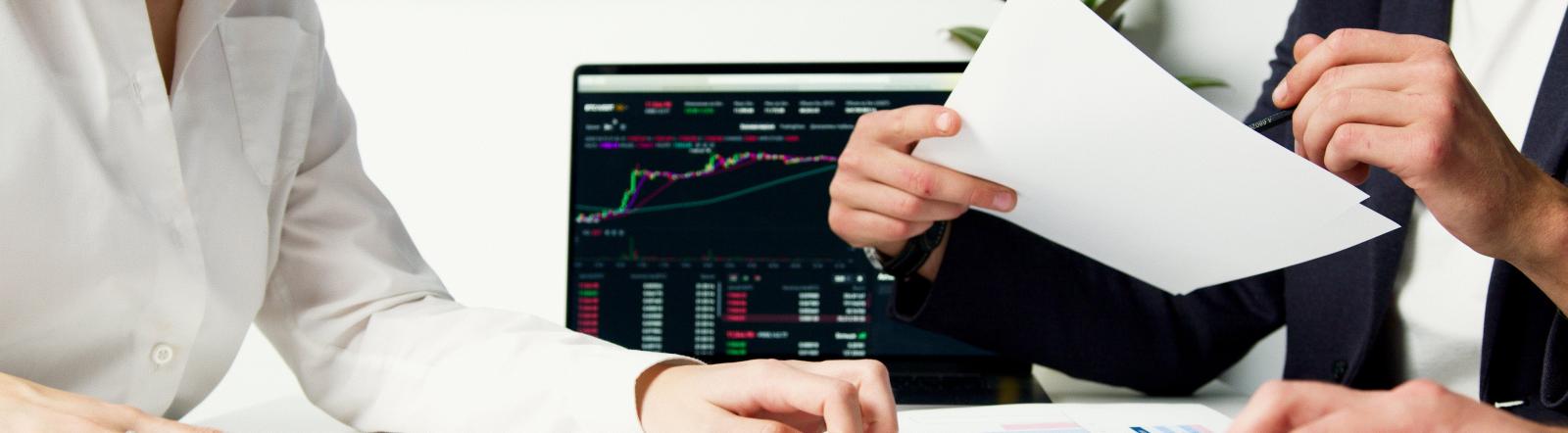 Deals being made at a desk with a man and woman