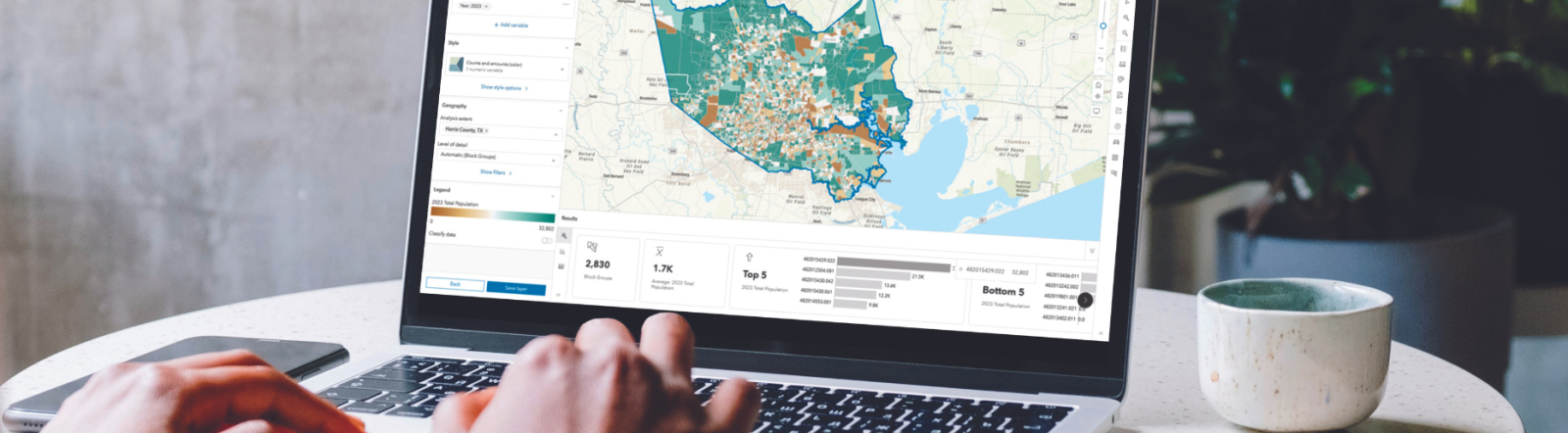 Woman working at a laptop using Esri's mapping tool.