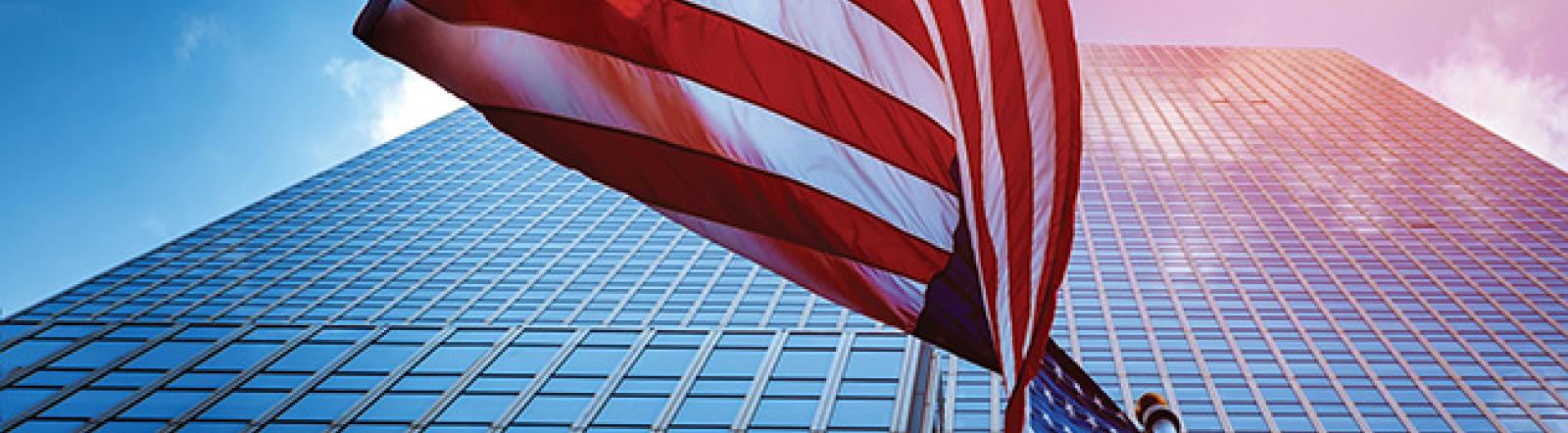 american flag in front of a large office building