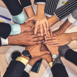 Multiple hands in a group cheer.