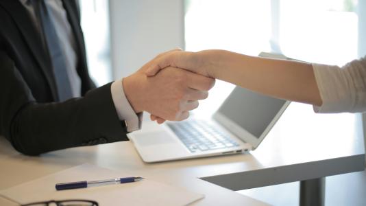 a man and a woman shaking hands in an office